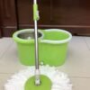 Heavy-duty 360-degree spin mop with stainless steel bucket and microfiber mop head on tiled floor